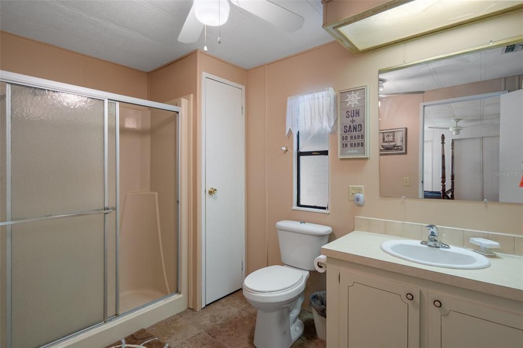 12306 Club House Road Brooksville, FL 34613 - Photo 12 of 36 a bathroom with a toilet sink and mirror