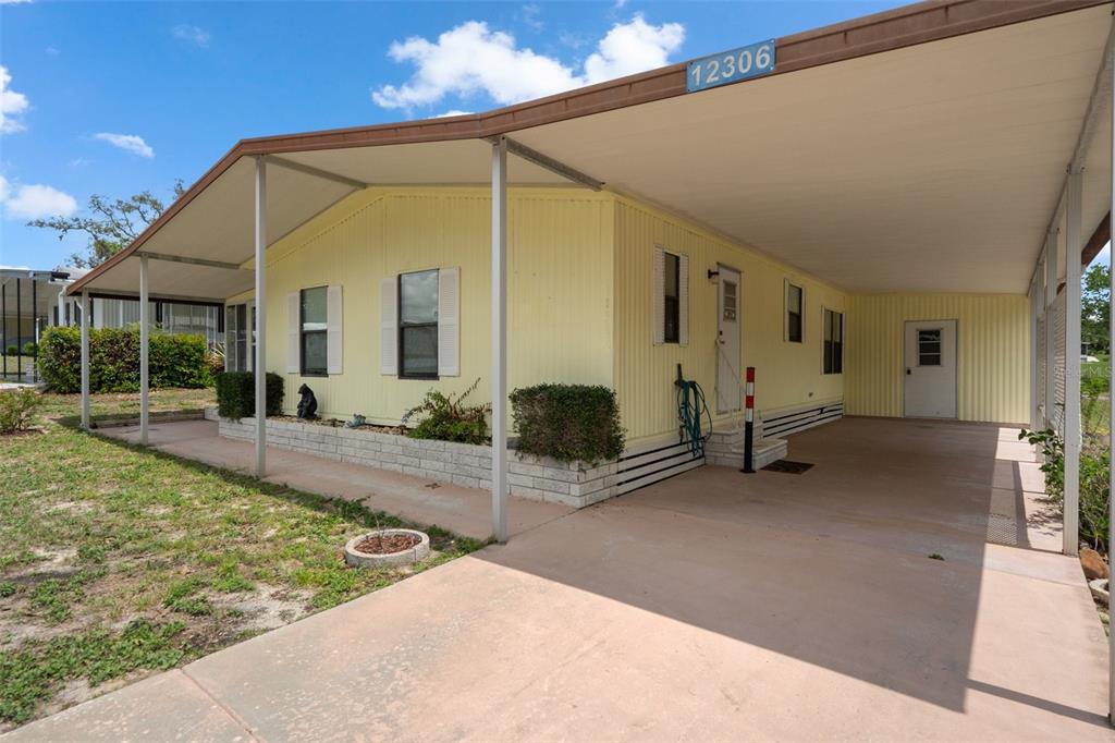 12306 Club House Road Brooksville, FL 34613 - Photo 13 of 36 a view of a house with backyard and porch