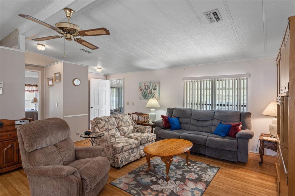 12306 Club House Road Brooksville, FL 34613 - Photo 15 of 36 a living room with furniture a fireplace and a window