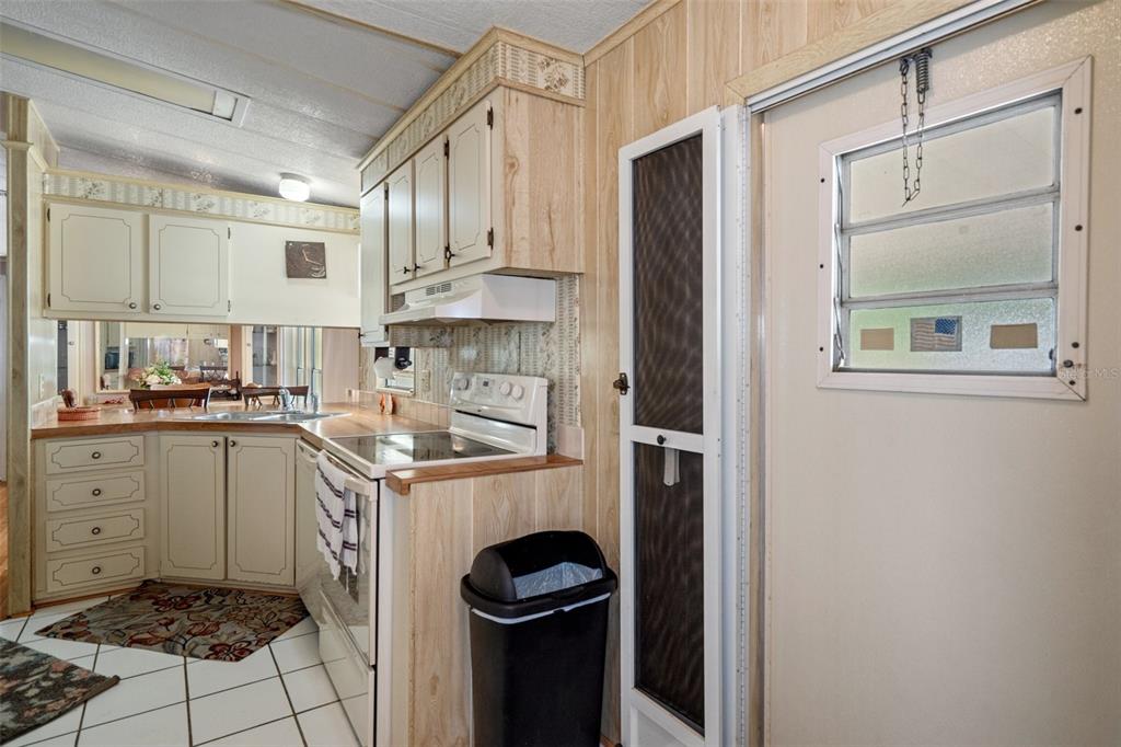 12306 Club House Road Brooksville, FL 34613 - Photo 20 of 36 a kitchen with a stove top oven and cabinets