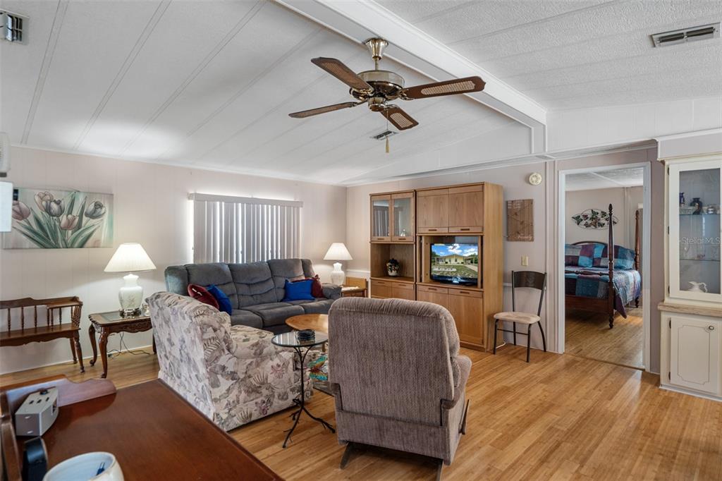 12306 Club House Road Brooksville, FL 34613 - Photo 2 of 36 a living room with furniture and a flat screen tv