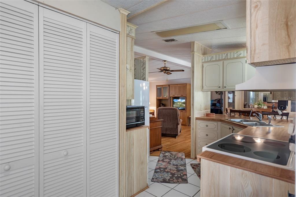 12306 Club House Road Brooksville, FL 34613 - Photo 21 of 36 a kitchen with a sink and cabinets