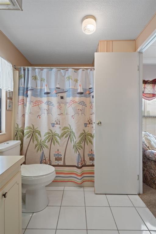 12306 Club House Road Brooksville, FL 34613 - Photo 26 of 36 a bathroom with a granite countertop sink a toilet and a shower