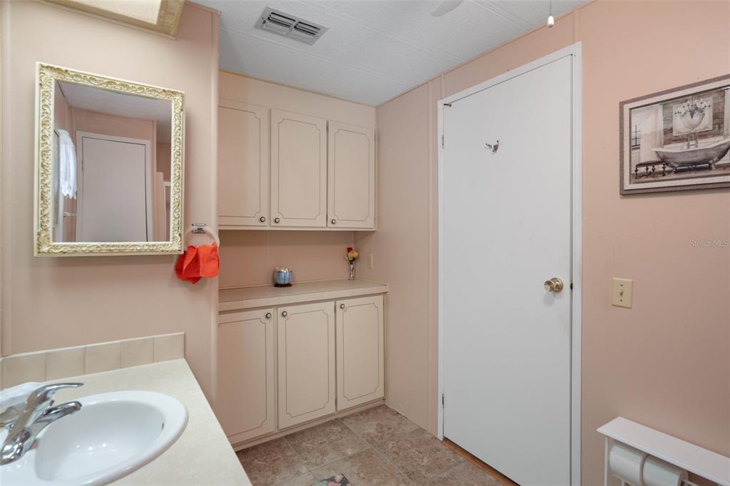 12306 Club House Road Brooksville, FL 34613 - Photo 29 of 36 a bathroom with a sink vanity and mirror