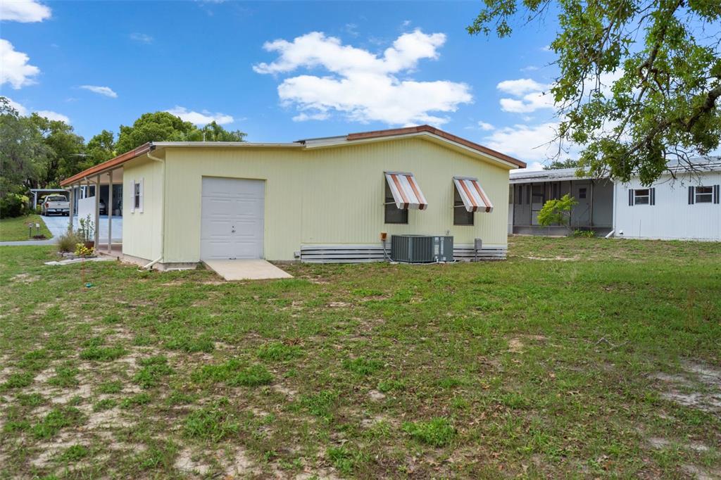 12306 Club House Road Brooksville, FL 34613 - Photo 32 of 36 a view of a house with a yard