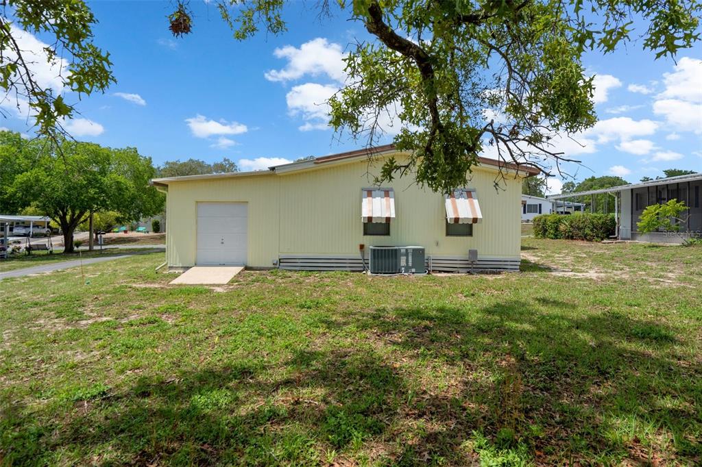 12306 Club House Road Brooksville, FL 34613 - Photo 33 of 36 a view of a house with a yard