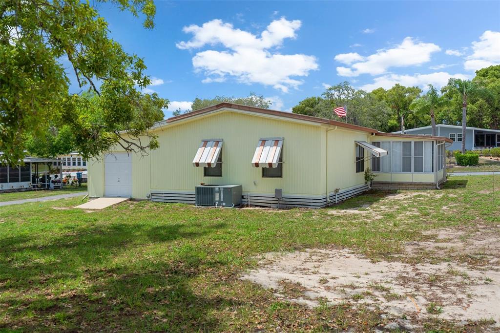 12306 Club House Road Brooksville, FL 34613 - Photo 34 of 36 a view of a backyard with a garden and entertaining space