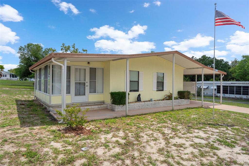 12306 Club House Road Brooksville, FL 34613 - Photo 35 of 36 a view of a house with backyard and sitting area