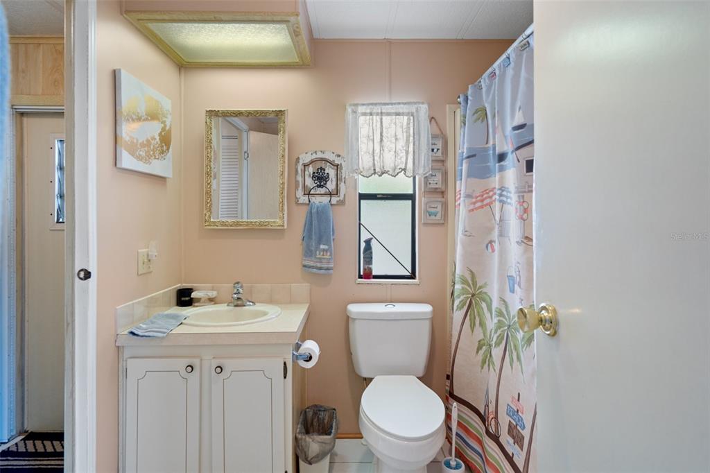 12306 Club House Road Brooksville, FL 34613 - Photo 4 of 36 a white toilet sitting next to a bathroom sink