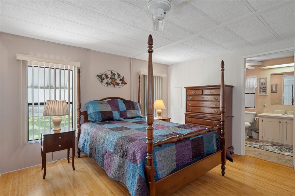 12306 Club House Road Brooksville, FL 34613 - Photo 8 of 36 a bedroom with bed and wooden floor