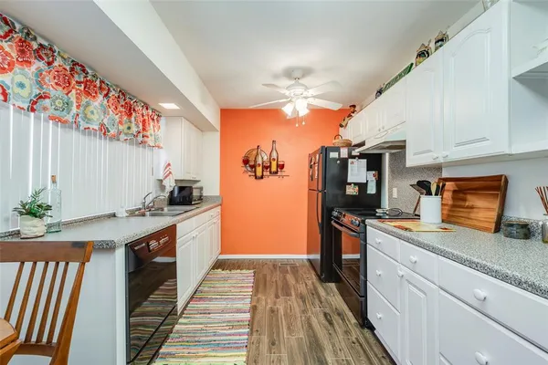 a kitchen with stainless steel appliances granite countertop a refrigerator and a stove