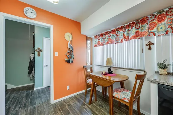 a dining room with furniture and wooden floor
