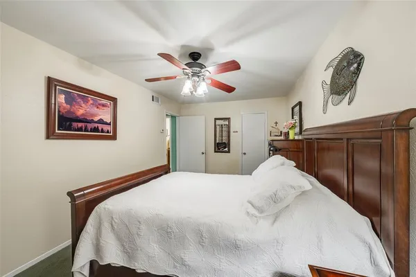 a bedroom with a large bed and a chandelier