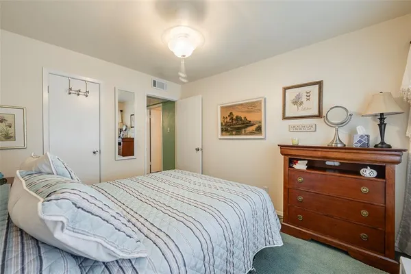 a bedroom with a bed and a dresser