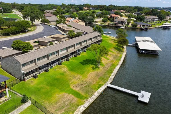 an aerial view of a house with a garden and lake view