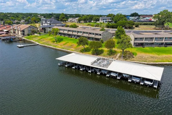 an aerial view of a house with a garden and lake view
