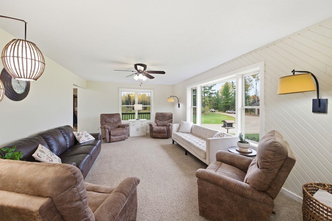 64903 Charles Johnson Road Ashland, WI 54806 - Photo 11 of 52 Carpeted living room with a ceiling fan