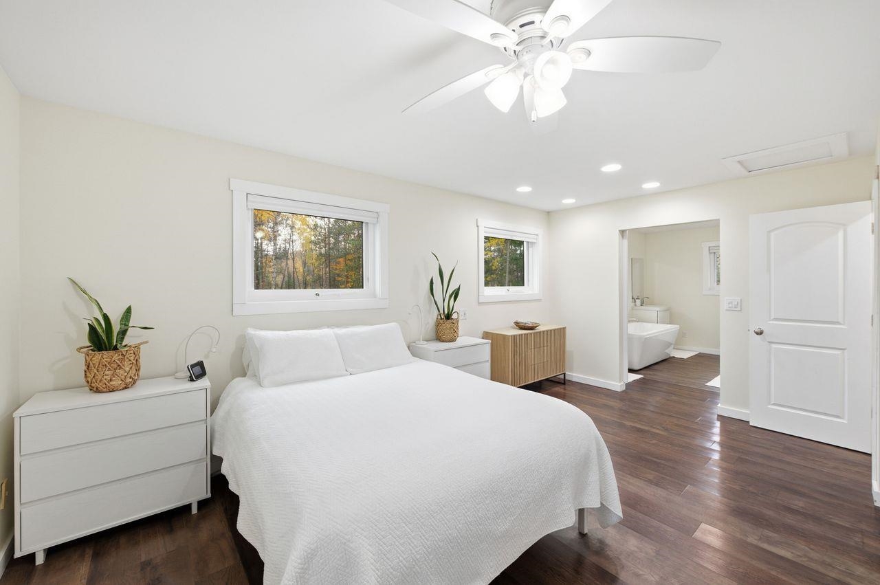 64903 Charles Johnson Road Ashland, WI 54806 - Photo 17 of 52 Bedroom featuring dark wood-type flooring, recessed lighting, attic access, ceiling fan, and ensuite bath