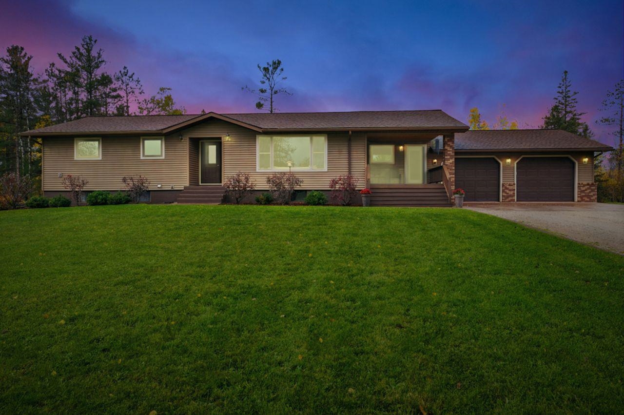 64903 Charles Johnson Road Ashland, WI 54806 - Photo 2 of 52 Ranch-style house featuring a front lawn, driveway, entry steps, and an attached garage