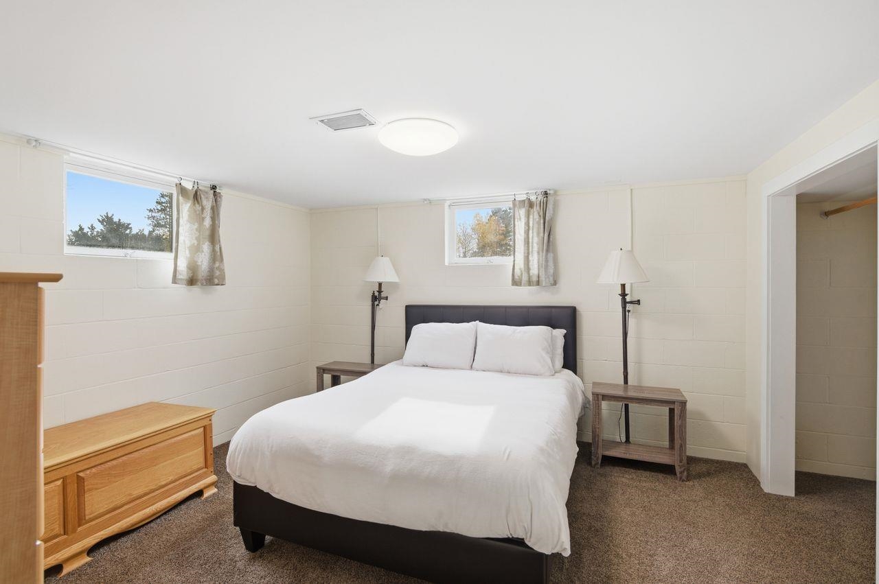 64903 Charles Johnson Road Ashland, WI 54806 - Photo 25 of 52 Carpeted bedroom featuring concrete block wall