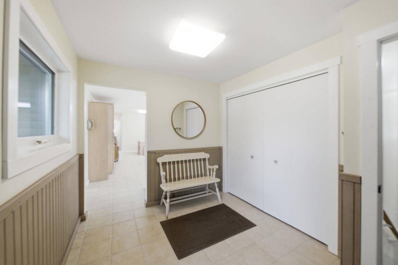 64903 Charles Johnson Road Ashland, WI 54806 - Photo 33 of 52 Corridor featuring radiator heating unit and a wainscoted wall