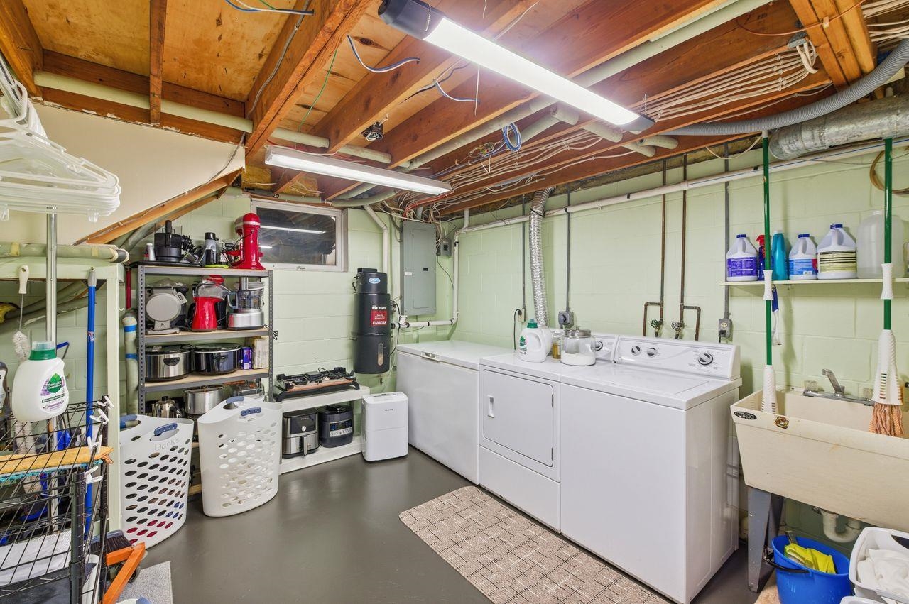 64903 Charles Johnson Road Ashland, WI 54806 - Photo 35 of 52 Washroom featuring finished concrete flooring, electric panel, and washer and dryer
