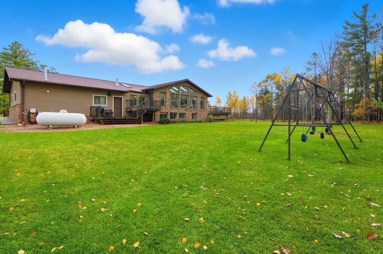 64903 Charles Johnson Road Ashland, WI 54806 - Photo 49 of 52 View of green lawn with a wooden deck and a playground