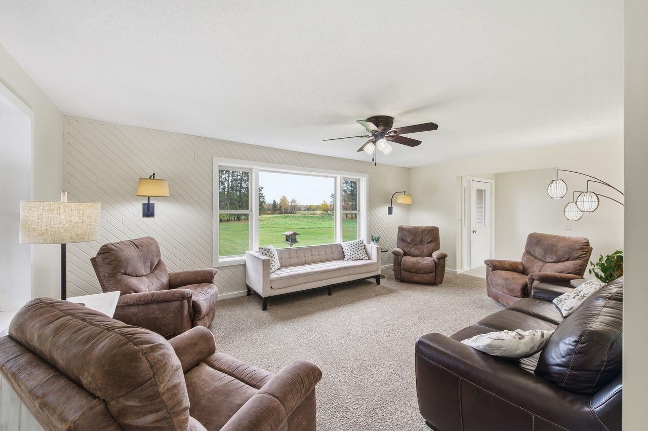64903 Charles Johnson Road Ashland, WI 54806 - Photo 7 of 52 Carpeted living area with ceiling fan