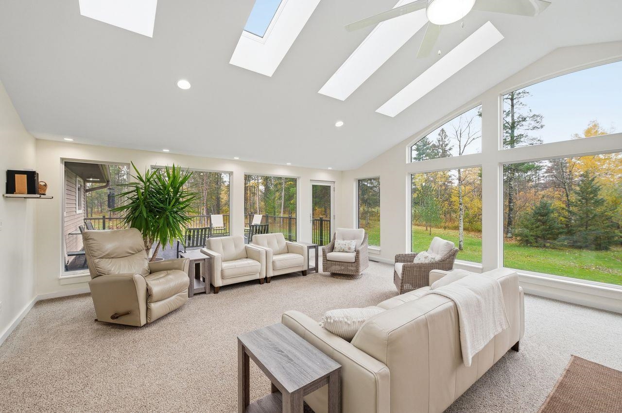 64903 Charles Johnson Road Ashland, WI 54806 - Photo 9 of 52 Sunroom with carpet flooring, high vaulted ceiling, a skylight, and recessed lighting