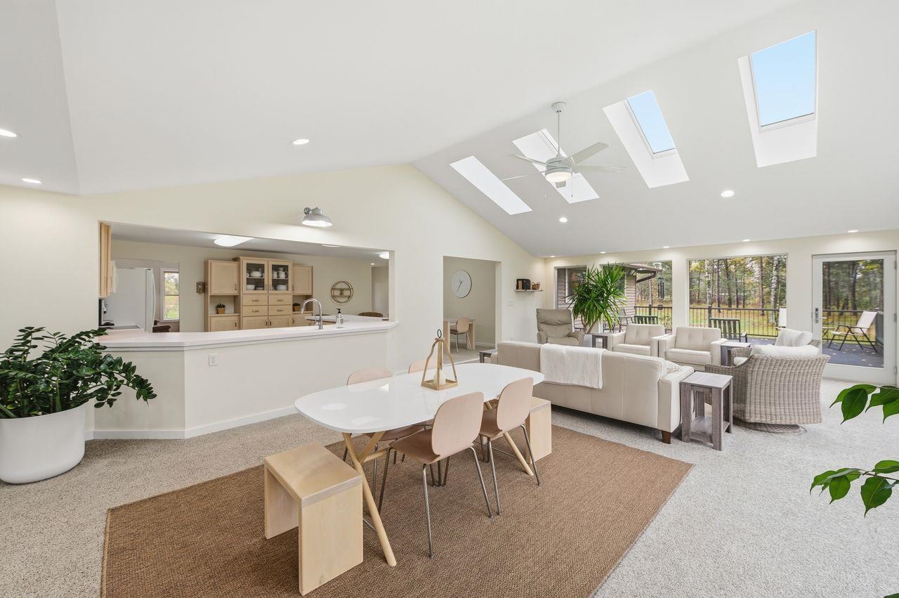 64903 Charles Johnson Road Ashland, WI 54806 - Photo 10 of 52 Carpeted dining area with high vaulted ceiling, recessed lighting, and a skylight