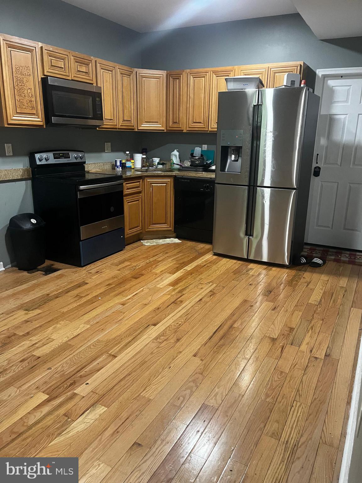 1507 West Susquehanna Avenue Philadelphia, PA 19132 - Photo 7 of 10 a kitchen with granite countertop a refrigerator stove and sink