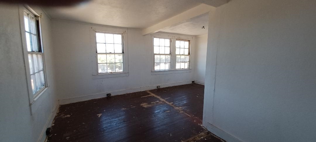2676 Kalanikahua Road Haiku, HI 96708 - Photo 15 of 18 an empty room with wooden floor and windows