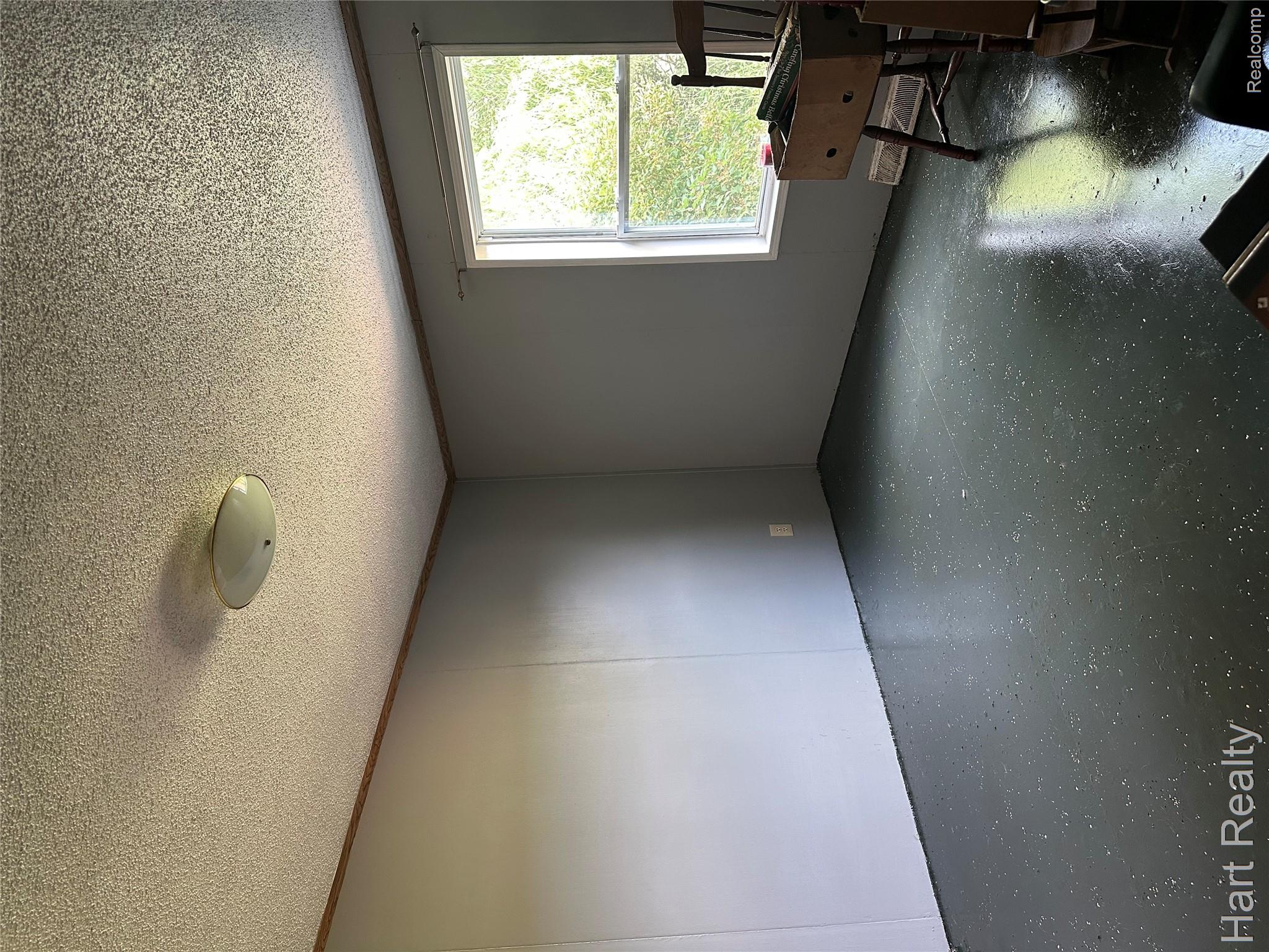 15686 Jeddo Road Brown City, MI 48416 - Photo 19 of 25 Room featuring a single window, a ceiling-mounted light fixture, and textured ceilings