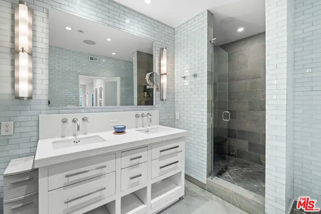 a bathroom with a shower sink and mirror