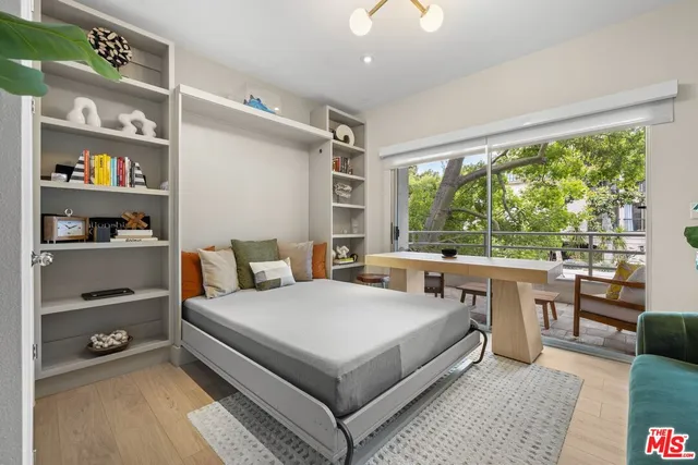 a bedroom with a bed and a large window