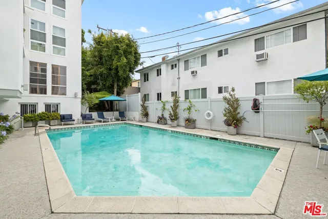 a swimming pool with outdoor seating and yard