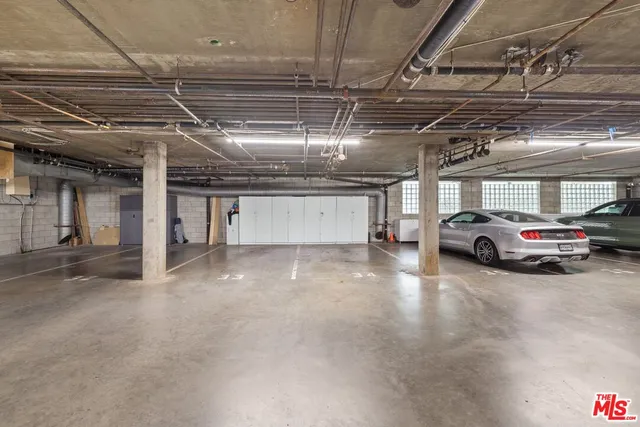 a view of parking garage with cars parked