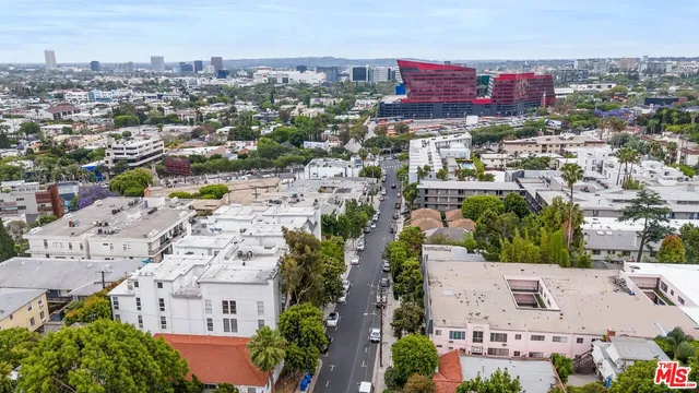 an aerial view of residential houses with city view