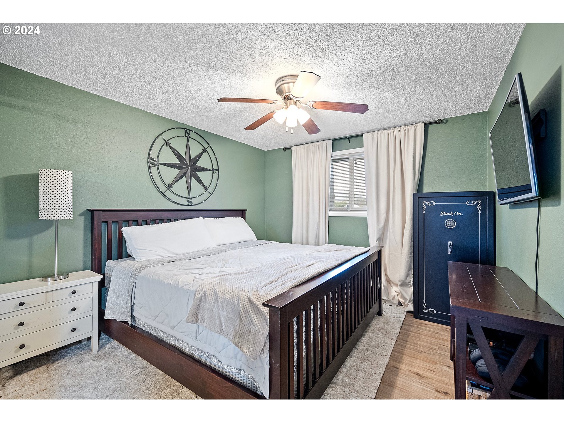 525 South 35th Street Springfield, OR 97478 - Photo 21 of 40 a bedroom with a bed and a chandelier
