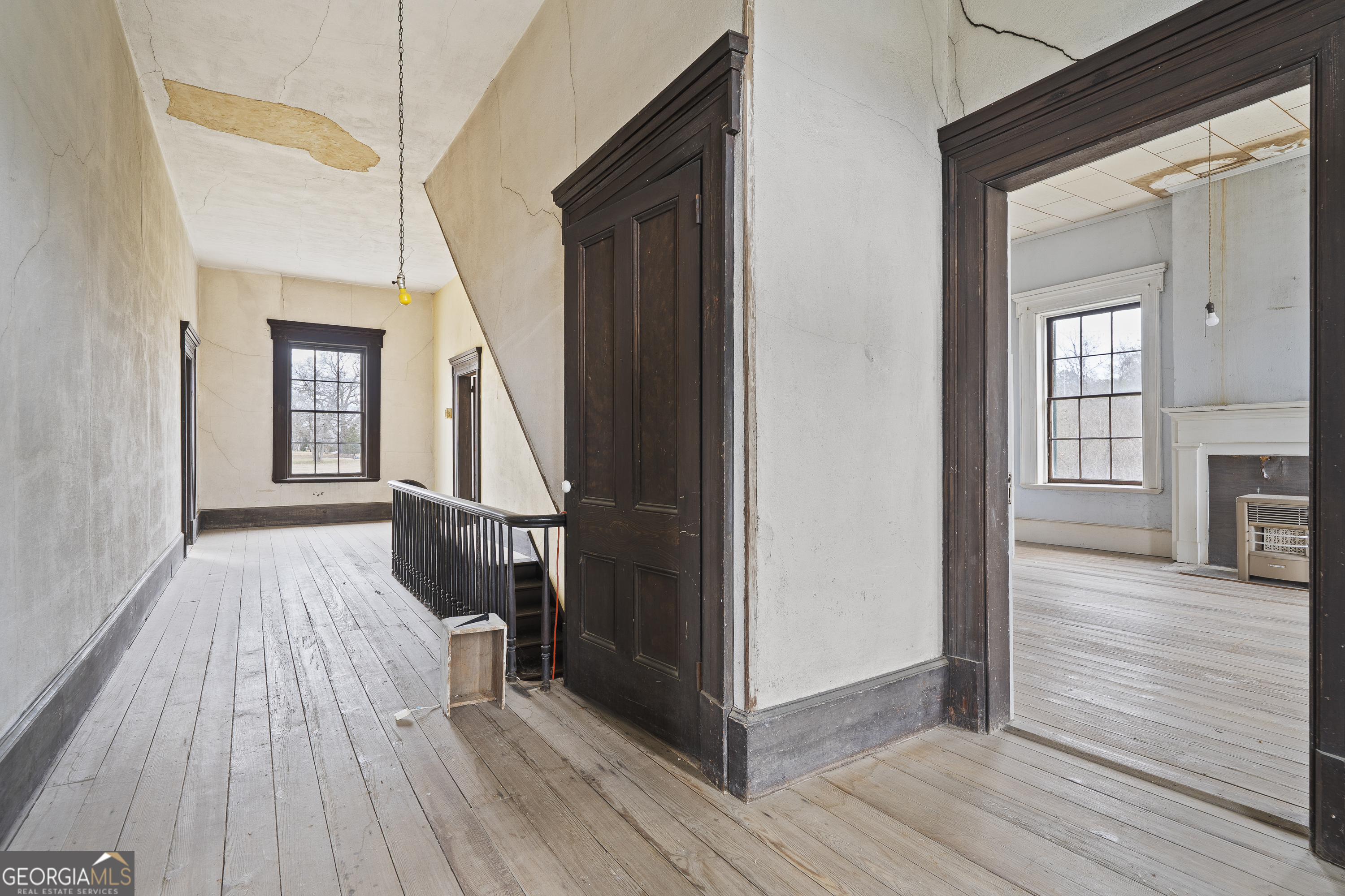 12871 Linton Road Sparta, GA 31087 - Photo 14 of 52 a view of a livingroom with wooden floor and stairs