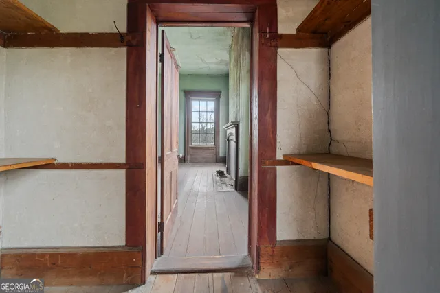 an empty room with furniture and fireplace