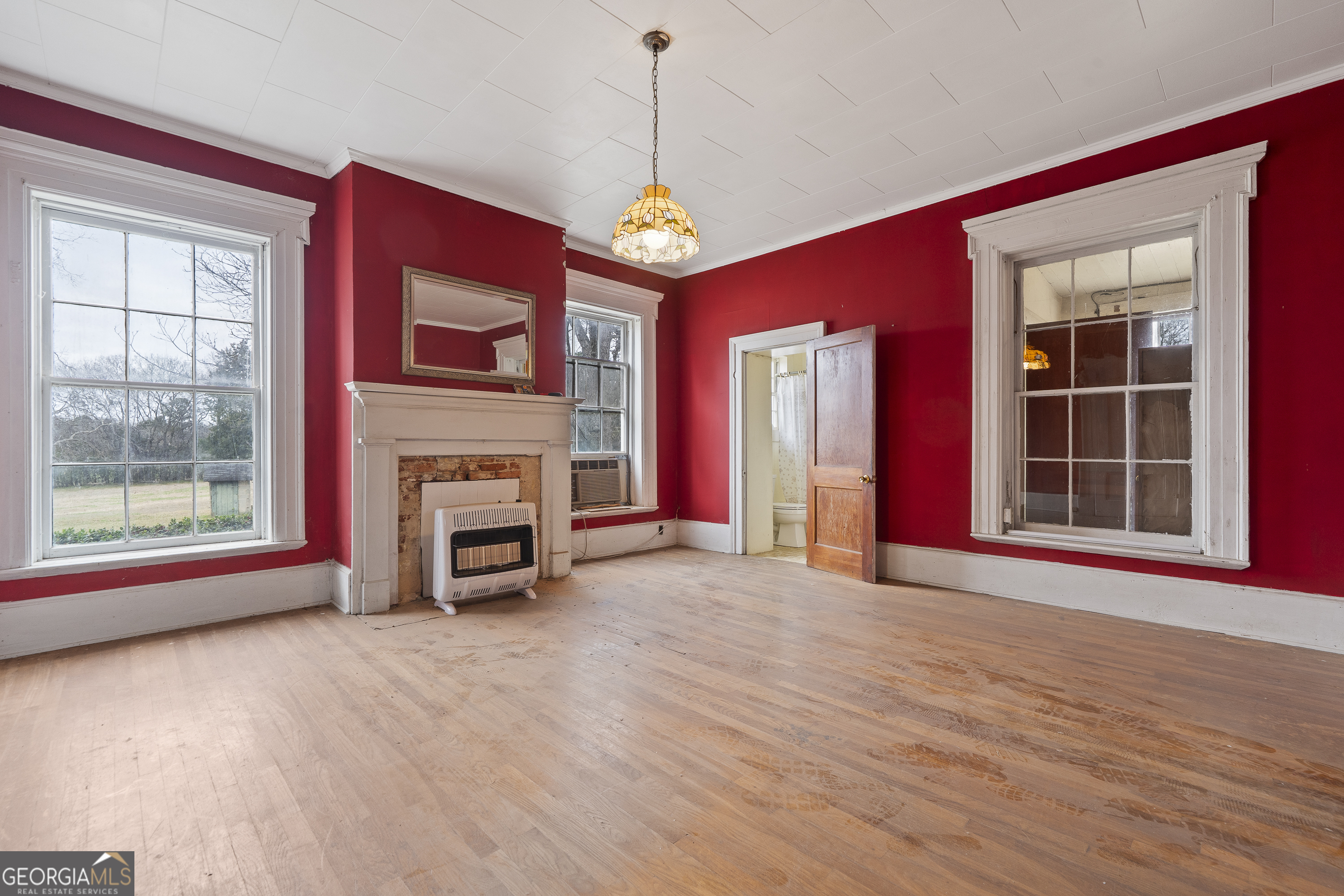 12871 Linton Road Sparta, GA 31087 - Photo 31 of 52 a view of an empty room with a fireplace and a window