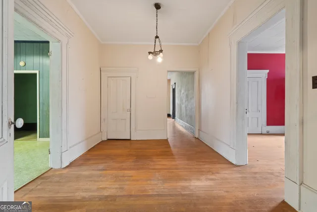 an empty room with a fireplace and windows