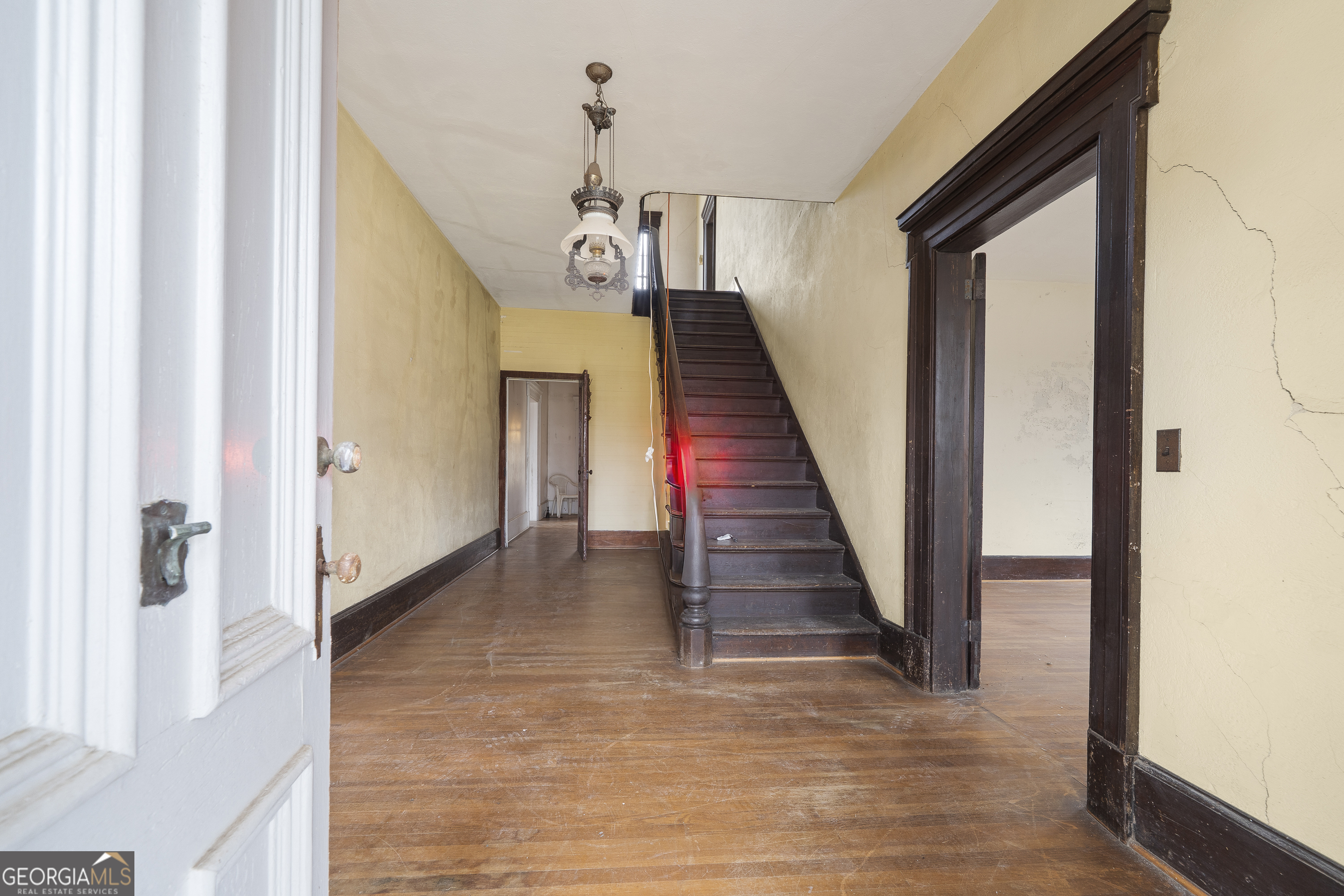12871 Linton Road Sparta, GA 31087 - Photo 44 of 52 a view of a hallway with wooden floor and staircase