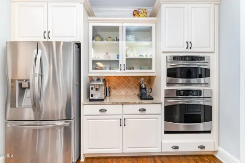 a kitchen with stainless steel appliances granite countertop a stove and cabinets