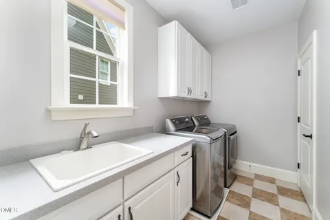 a living room with stainless steel appliances kitchen island granite countertop a table and a chair