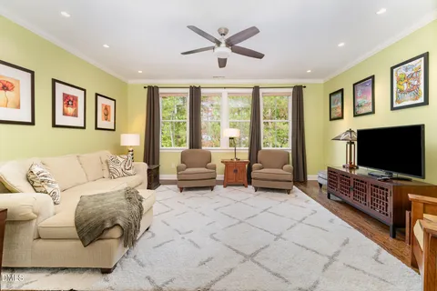 a bedroom with a bed and a flat tv screen on dresser