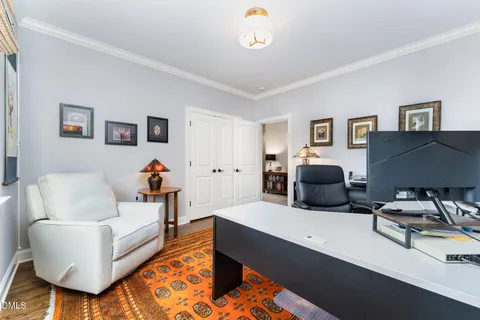 a bedroom with a bed and a dresser with mirror