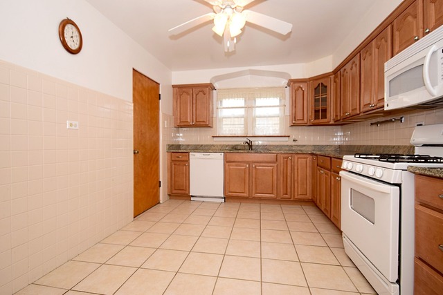 439 Shenstone Road Riverside, IL 60546 - Photo 11 of 25 a kitchen with stainless steel appliances granite countertop a stove a sink dishwasher and a refrigerator