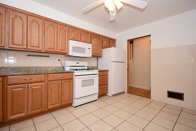 439 Shenstone Road Riverside, IL 60546 - Photo 13 of 25 a kitchen with white cabinets and white appliances